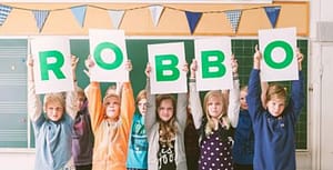 children holding ROBBO sign